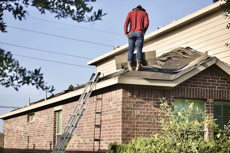 Professional roofer working on a residential roof in Hidden Creek